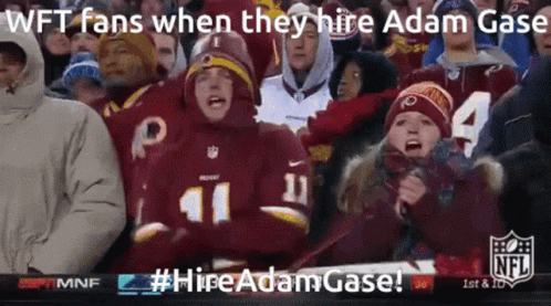 A Crowd Of People Are Watching A Football Game And One Of Them Is Wearing A Redskins Uniform GIF
