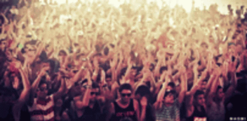 A Crowd Of People At A Concert With One Man Wearing A Shirt That Says ' O.k.f.w. ' GIF