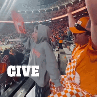 A Crowd Of People In A Stadium With The Word Give In White GIF