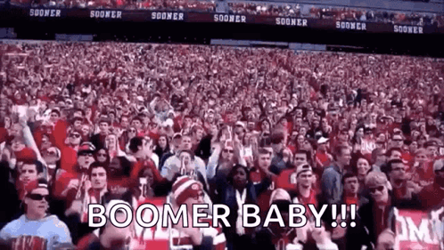 A Crowd Of People In A Stadium With The Words Boomer Baby ! GIF