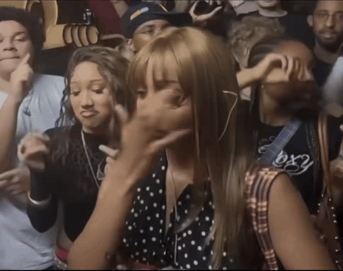 A Crowd Of People Including A Girl Wearing A Shirt That Says Bx2 GIF