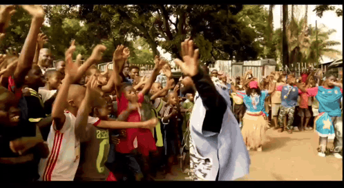 A Crowd Of People Including A Man Wearing A Shirt That Says ' Rsr ' On It GIF