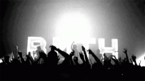 a crowd of people raising their hands in the air in front of a sign that says beth