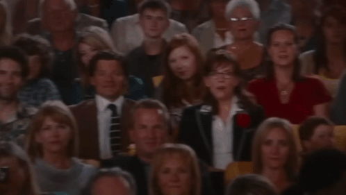 A Crowd Of People Sitting In A Stadium Watching A Presentation GIF