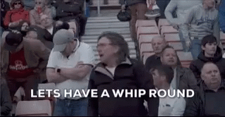 a crowd of people sitting in a stadium with the words `` let 's have a whip round '' written on the screen .