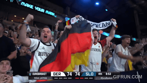 A Crowd Of People Watching A Basketball Game With A Scoreboard That Says Eurobasket Riga Latvia GIF