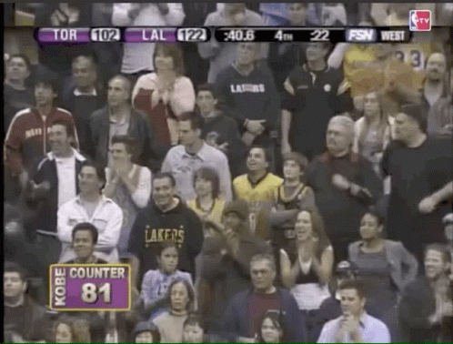 a crowd of people watching a basketball game with a sign that says kobe counter 81
