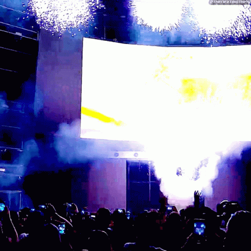 A Crowd Of People Watching A Fireworks Display With The Hashtag #Thenextbigthing GIF