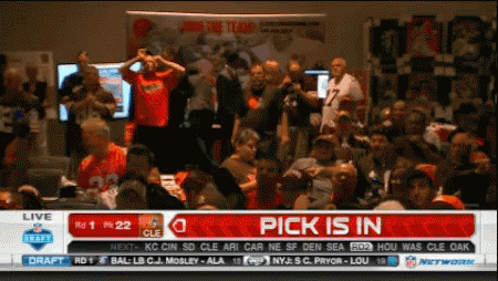 A Crowd Of People Watching A Football Game With A Pick Is In Banner On The Screen GIF