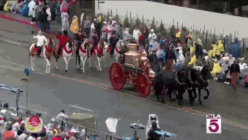 A Crowd Of People Watching A Parade With The Number 5 In The Corner GIF