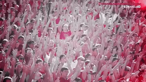 A Crowd Of People With Their Arms In The Air And The Website Kansasrazorbacks.com GIF