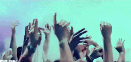 A Crowd Of People With Their Hands In The Air . GIF