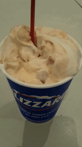 A Cup Of Blizzard Ice Cream With A Straw In It GIF