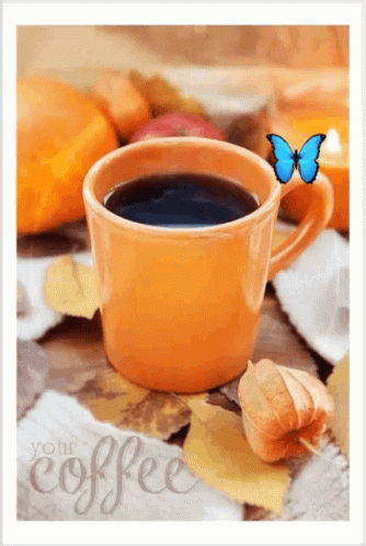 A Cup Of Coffee Is Surrounded By Autumn Leaves And A Butterfly GIF