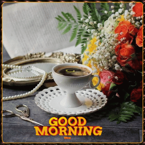 A Cup Of Coffee Sits On A Saucer Next To A Bouquet Of Flowers And Pearls GIF