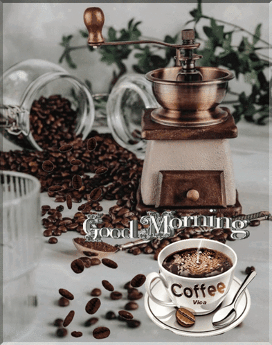 A Cup Of Coffee Sits On A Saucer Next To A Coffee Grinder With The Words Good Morning Written On It GIF