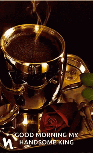 A Cup Of Coffee Sits On A Saucer Next To A Rose GIF