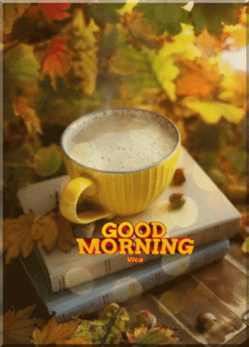 A Cup Of Coffee Sits On Top Of A Stack Of Books With The Words Good Morning Written On The Bottom GIF