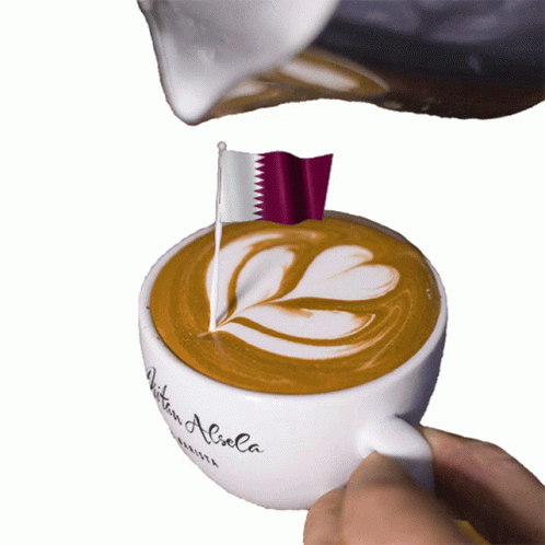 A Cup Of Coffee With A Flag On Top Of It GIF