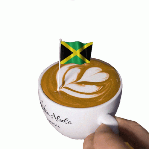 A Cup Of Coffee With A Small Jamaican Flag On Top Of It GIF