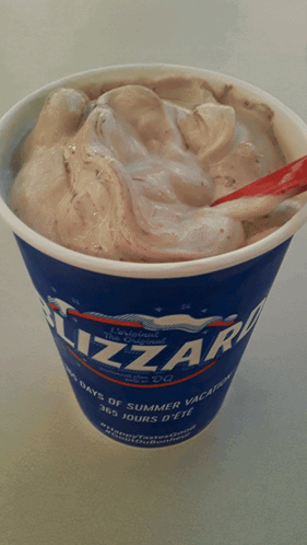 A Cup Of Dairy Queen Blizzard Ice Cream With A Red Spoon GIF