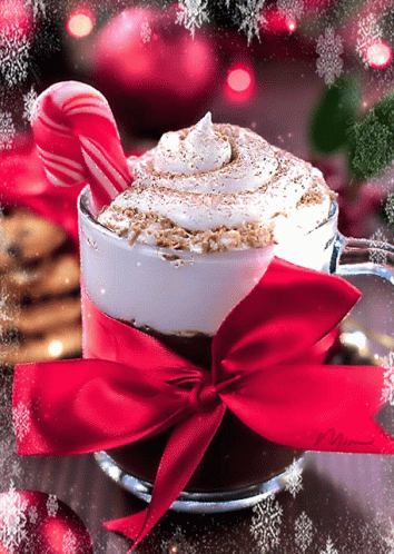 A Cup Of Hot Chocolate With A Red Bow And Candy Cane GIF
