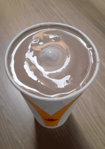 A Cup Of Milkshake With A Swirl On Top GIF