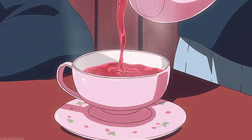 A Cup Of Tea Is Being Poured From A Teapot Into A Cup GIF