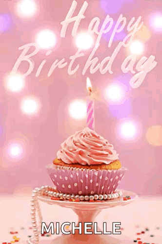 A Cupcake With A Pink Frosting And A Lit Candle Is On A Plate With The Name Michelle On It GIF
