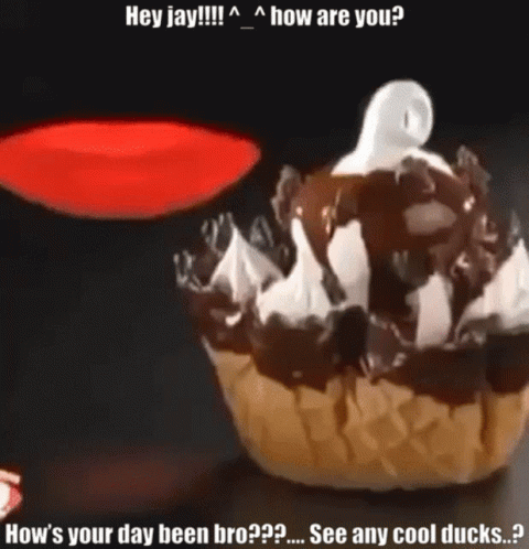 A Cupcake With Chocolate Sauce And Whipped Cream Has A Ghost On Top Of It GIF
