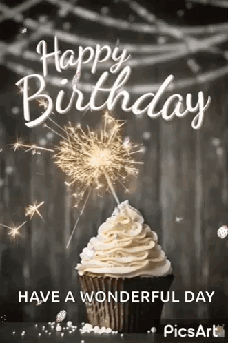 A Cupcake With Whipped Cream And A Sparkler On Top Of It . GIF