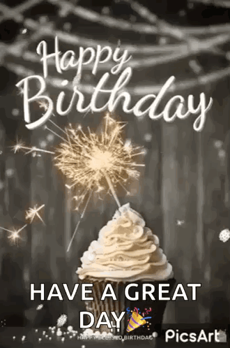 A Cupcake With Whipped Cream And A Sparkler On Top Of It . GIF