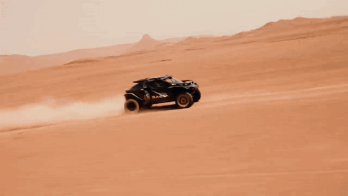 A Dacia Vehicle Is Driving Through A Desert GIF