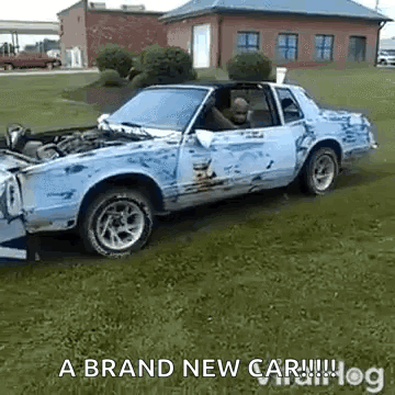 A Damaged Car Is Parked In A Grassy Field With The Words A Brand New Car GIF