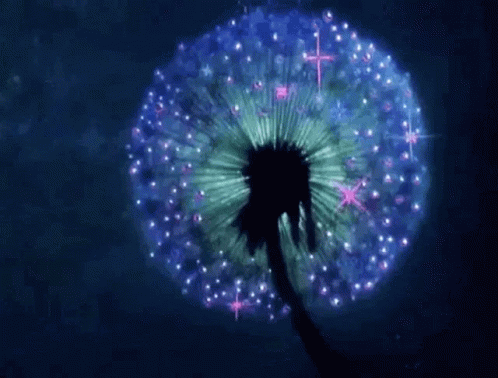 A Dandelion With Purple And Green Petals Is Glowing In The Dark . GIF
