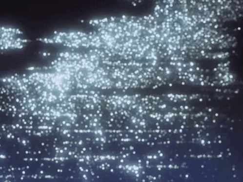 A Dark Background With A Lot Of White Sparkles On It GIF