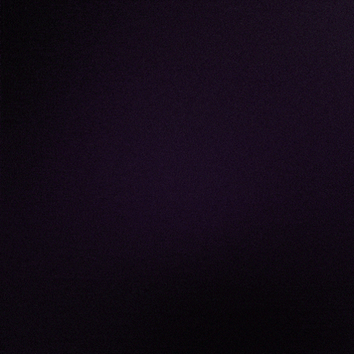 A Dark Background With A Purple Glowing Object In The Center GIF