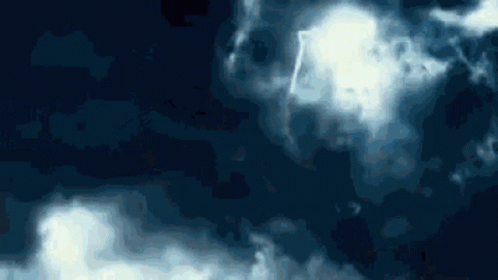 A Dark Blue Background With White Clouds Floating In It GIF