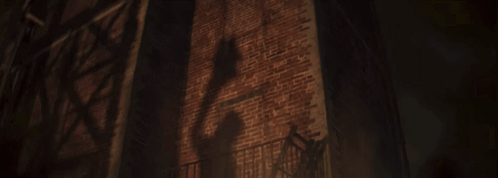 A Dark Brick Wall With A Fire Escape In Front Of It GIF