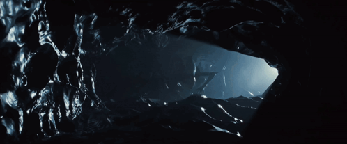 A Dark Cave With A Light Coming Out Of The Corner GIF