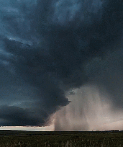 A Dark Cloudy Sky With A Few White Clouds GIF