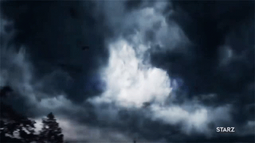 A Dark Cloudy Sky With A Starz Logo In The Lower Right Corner GIF