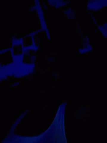 a dark room with a blue light shining on the wall