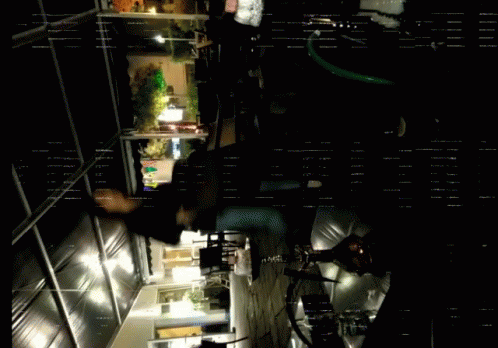 A Dark Room With A Few Lights On And A Few People GIF