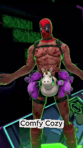 a deadpool holding a stuffed unicorn and teddy bears with the words comfy cozy below him