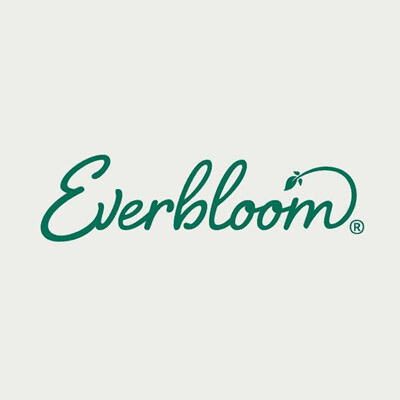 A Deck With A Table And Chairs Under An Umbrella With The Word Everbloom On The Bottom GIF