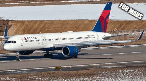A Delta Airplane Is Sitting On The Runway GIF