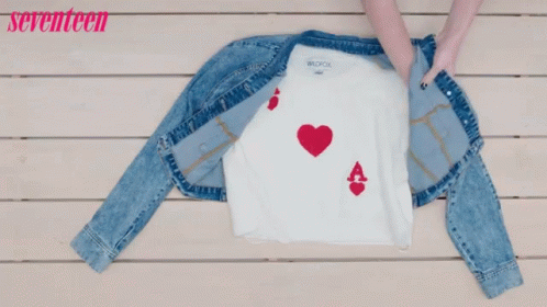 A Denim Jacket And Jeans Are On A Wooden Table With The Words Seventeen In Pink GIF
