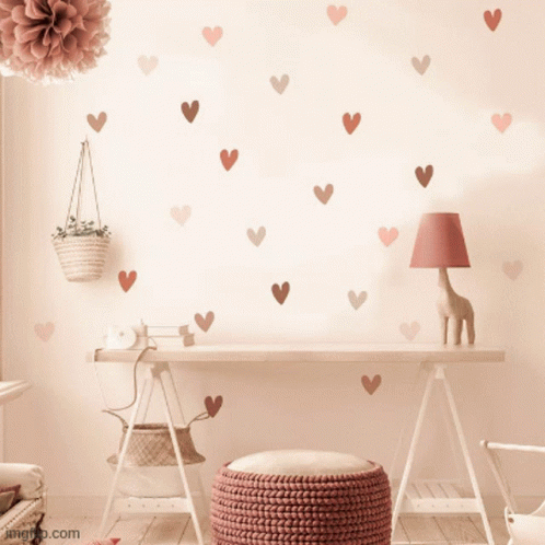 A Desk With Hearts On The Wall And A Lamp GIF