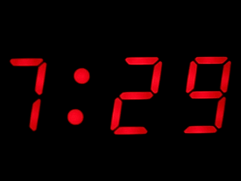 A Digital Clock Displays The Time As 7:30 On A Black Background GIF